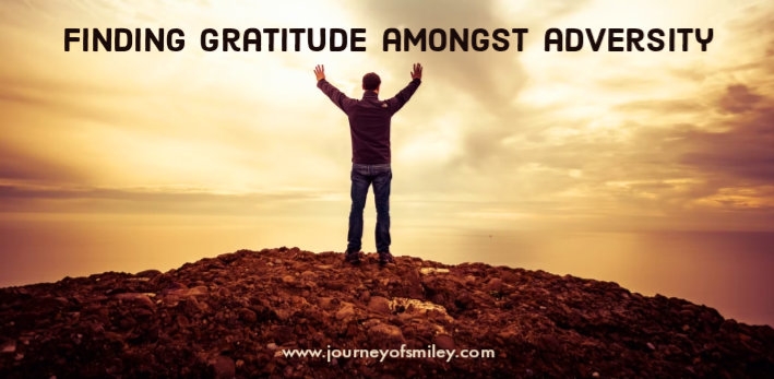 a man with arms up to heaven with finding gratitude blog post title on Journeyofsmiley blog