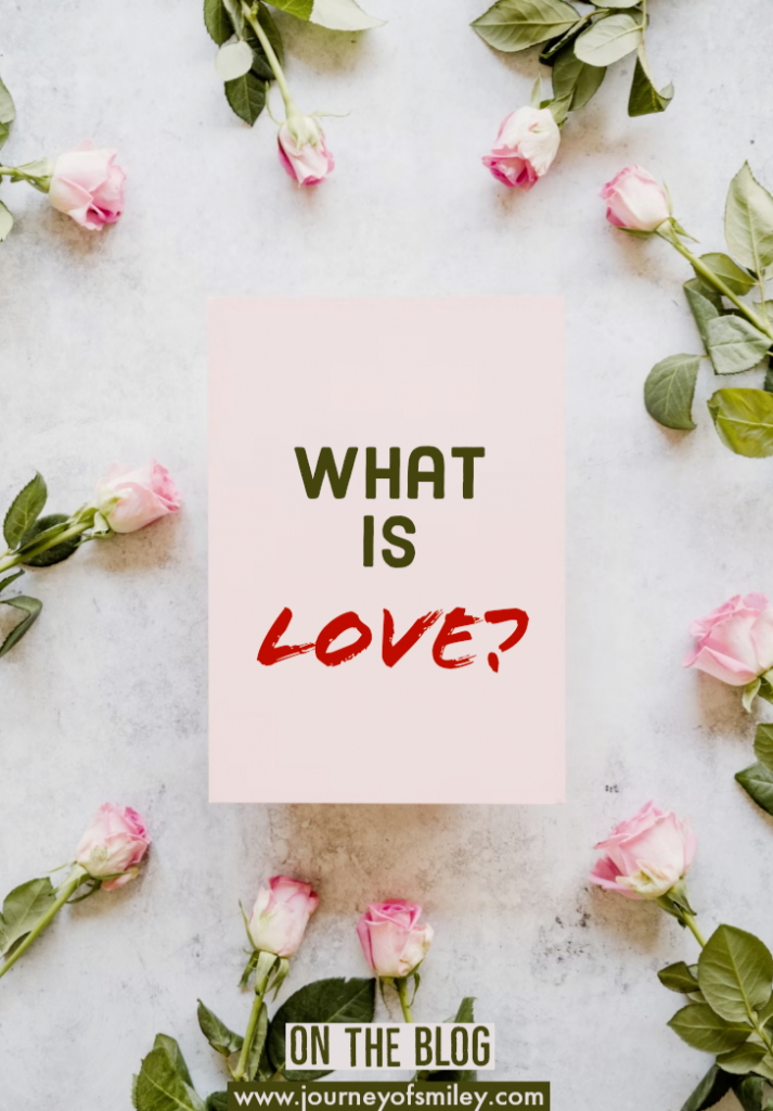 a pink paper note with what is love in the middle and pink roses around the paper in a circle, title on Journeyofsmiley blog