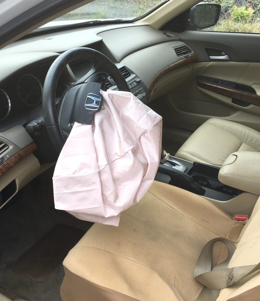 Driver seat with an exploded airbag in the front in a car