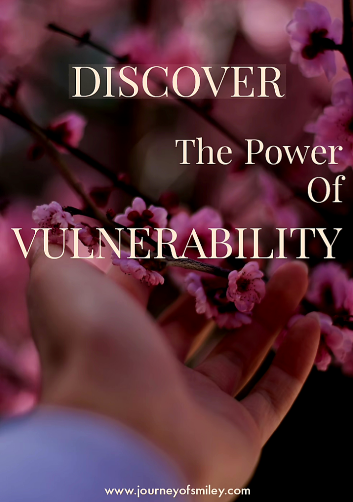 A hand touching a tree brunch with pink flowers on it and the title is The Power of Vulnerability on Journeyofsmiley Blog