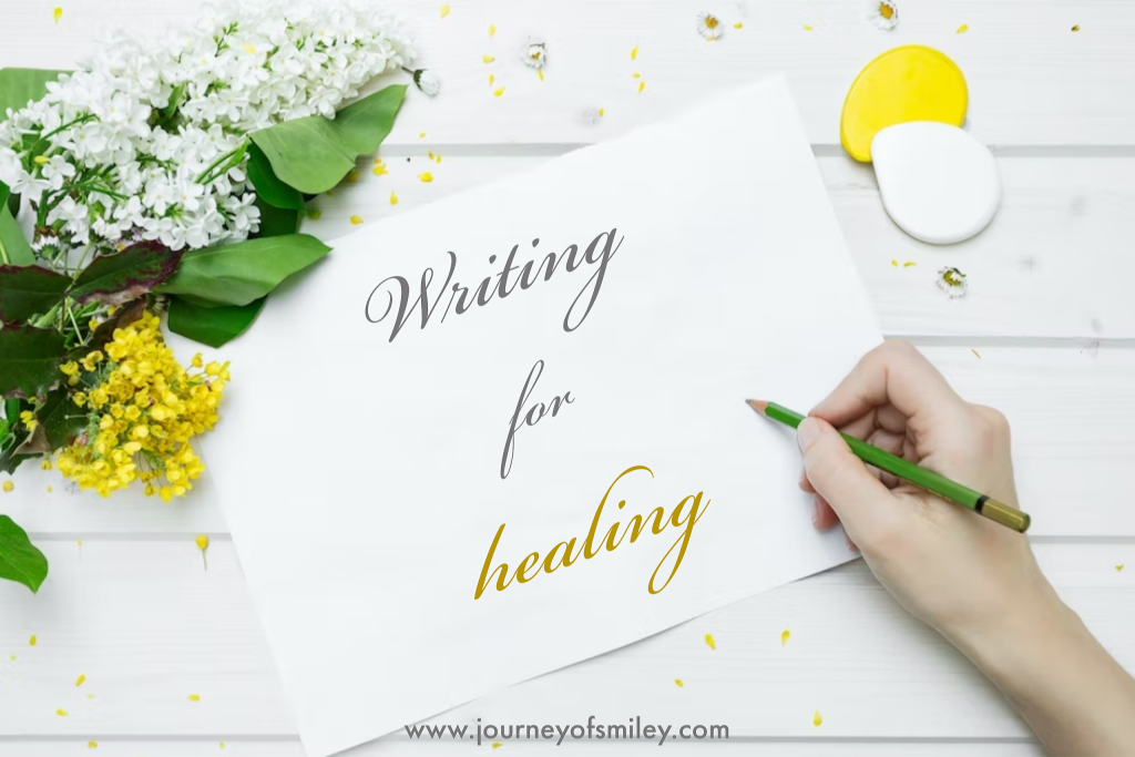 Flower on a piece of paper and on the paper is written Writing for healing on Journeyofsmiley blog