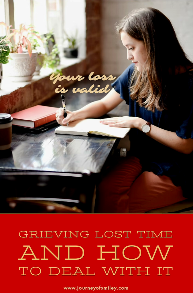 A woman sitting at a table writing in a notepad and there's written 'your loss is valid' and below is the title, 'Grieving lost time and how to deal with it' on Journeyofsmiley blog