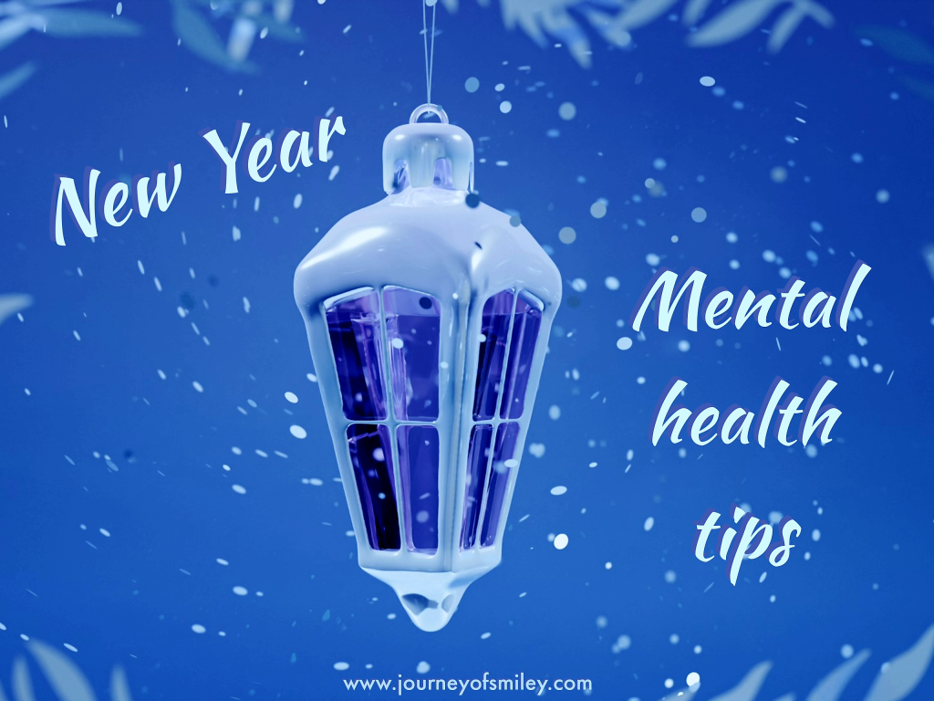 Blue frosty background with a lantern light in the middle, frosty wintery image and below is the title Top New Year Mental Health Tips on Journeyofsmiley blog