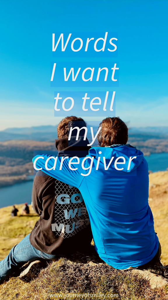 Two people sitting facing backwards, one is holding the other around their shoulders. They are in nature, lake and forest below them, and the title in the middle says Words I want to tell my caregiver on Journeyofsmileye blog