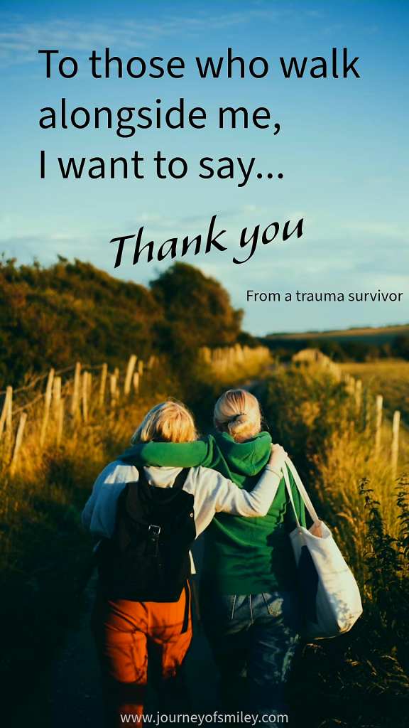 Two girls walking in nature, turned backwards, holding each other around their shoulders, and the title on the top, in the blue sky, is To those who walk alongside me, I want to say Thank you, from a trauma survivor, on Journeyofsmiley blog