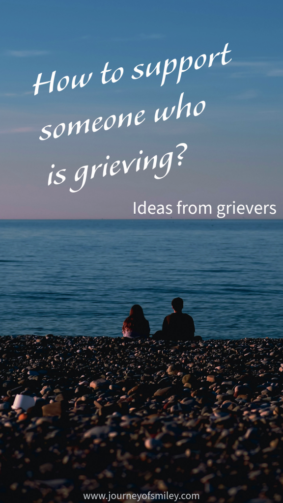 Seaside, two people, a man and a woman, sitting on a pebble beach, sea in the background, and above is the title How to support someone who is grieving, Ideas from grievers on Journeyofsmiley.com