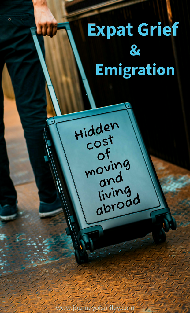 A male pulling a case with the sign Hidden cost of moving and living abroad on it and above is the title Expat Grief and Emigration on Journeyofsmiley.com