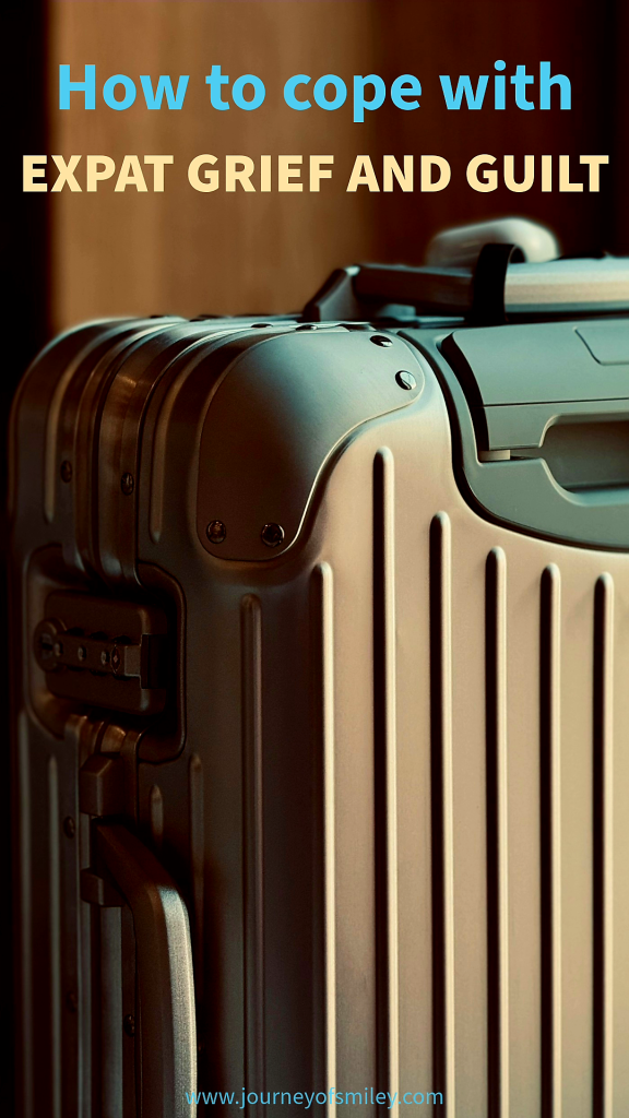 A big natural colour suitcase and above is the title How to cope with expat grief and guilt on Journeyofsmiley.com