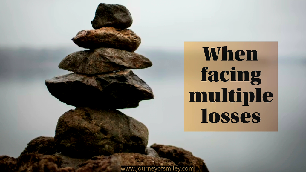 A picture of stones piling on each other, and next to it is the title When facing multiple losses on Journeyofsmiley blog