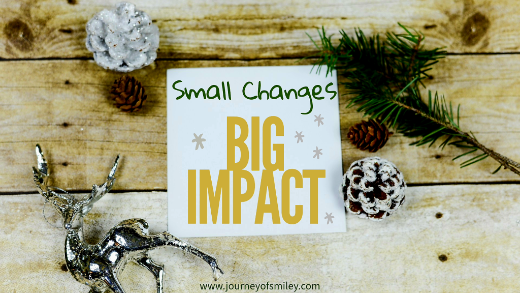 Christmas and new year's decorations around a paper in the middle and on that paper is written 'Small Changes, Big Impact' on Journeyofsmiley blog