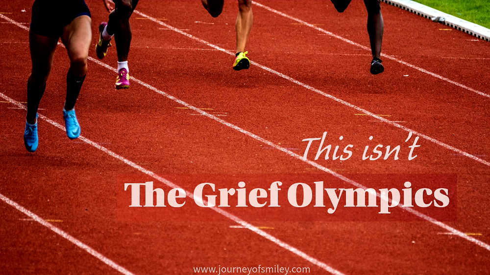 Running track, four pairs of legs running in lanes, and the title is This isn't the Grief Olympics on Journeyofsmiley blog