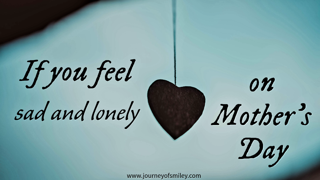 A black heart hanging on a sting in the middle of a blue background and the title is If you feel sad and lonely on Mother's Day on Journeyofsmiley blog